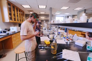 Philip Paulson ’12 and Associate Professor of Chemistry Kathleen Purvis-Roberts prepare a gas chromatography experiment in the W.M. Keck Science Department.